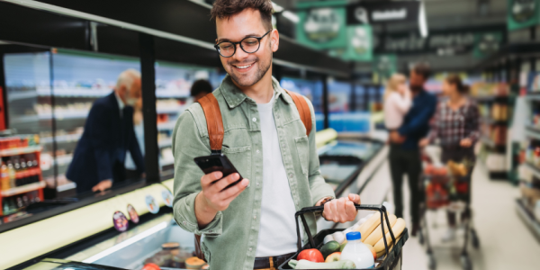 man-grocery-shopping-looking-at-phone