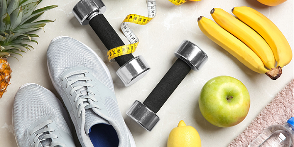 weight-loss-concept-with-fruit-shoes-weights-tape-measure